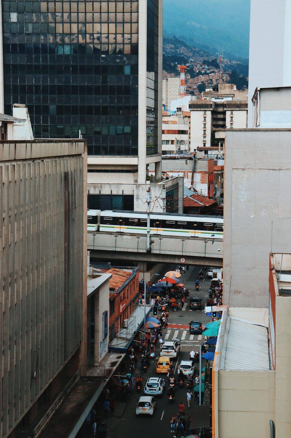 Busy downtown street with metro line and tall buildings in Medellín, Colombia