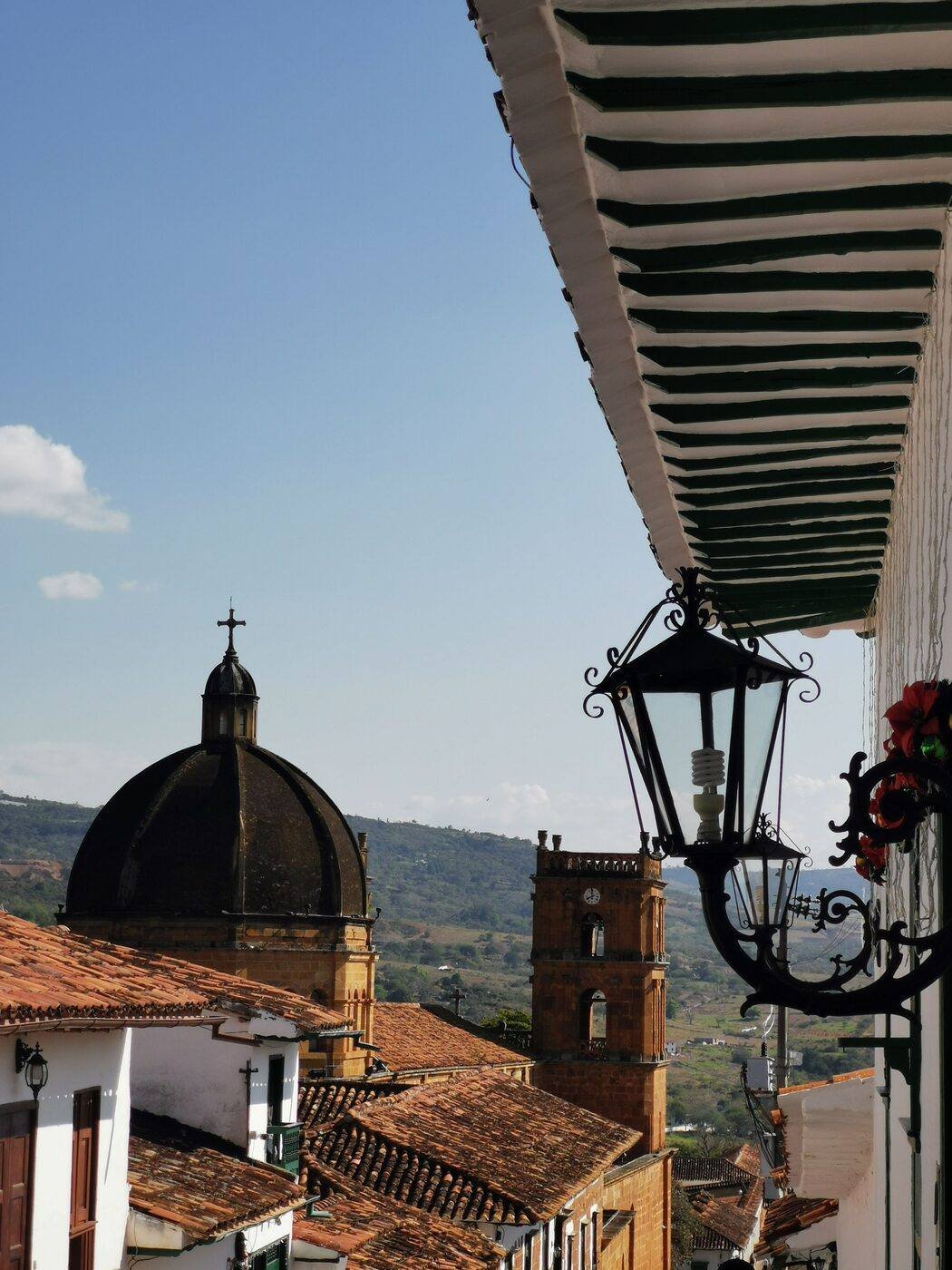 Cobblestone colonial street with whitewashed buildings and iron balconies in a Boyacá village, Colombia