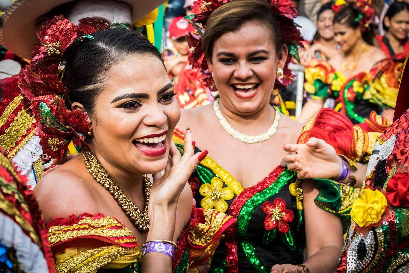 Women in vibrant traditional costumes celebrating Barranquilla Carnival, Colombia