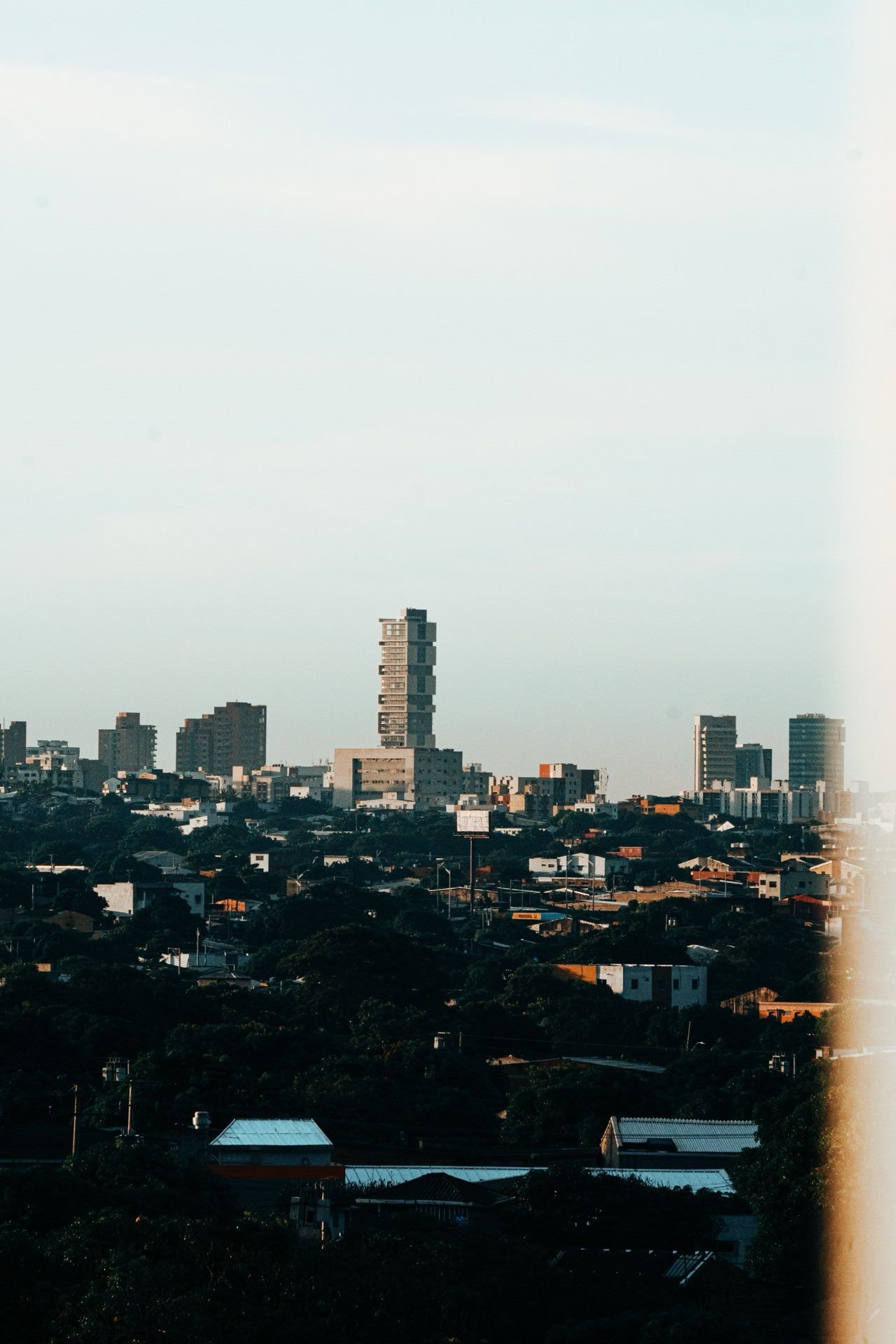 Barranquilla city skyline at dusk with modern towers and tropical rooftops, Colombia