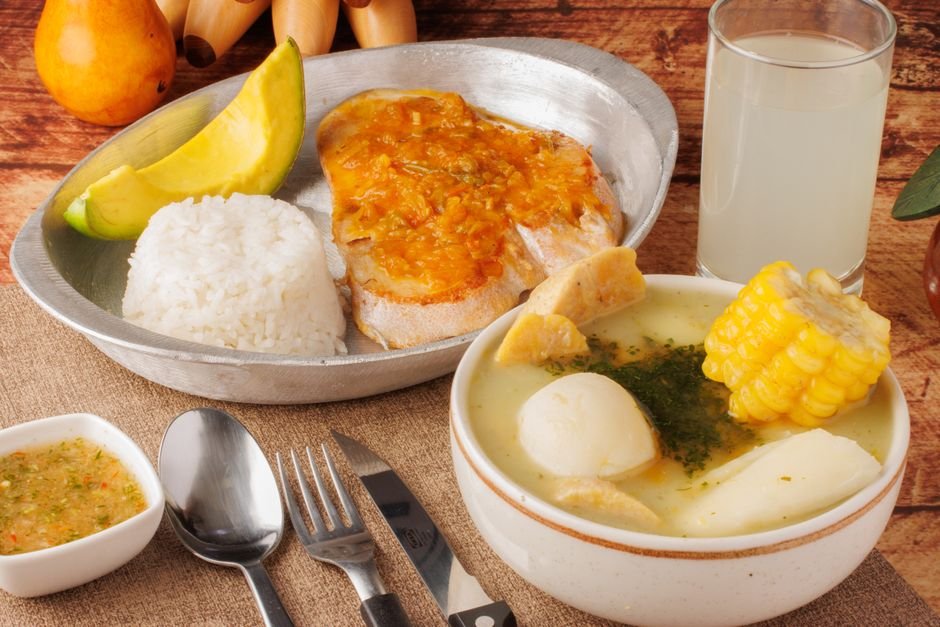 Traditional Santandereano spread with mute stew, chicharrón, arepa, and cabro at a Bucaramanga restaurant