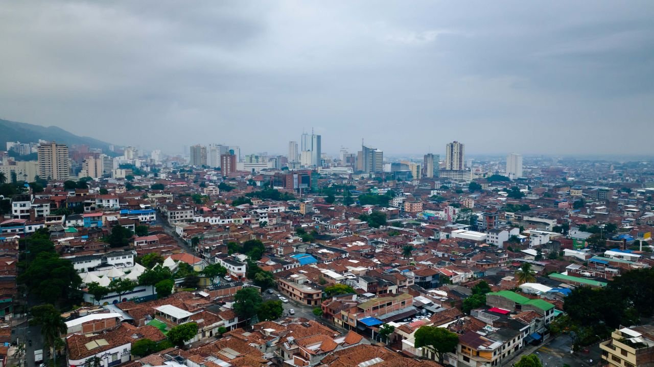 Overcast aerial view of Cali's terracotta rooftops with the mountains behind, Valle del Cauca, Colombia