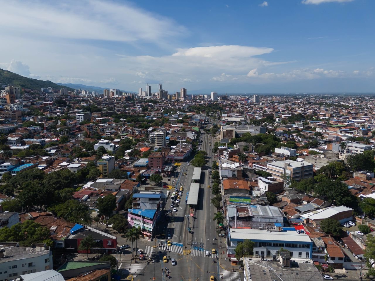 Aerial view of Cali's grid of streets and bus lane under a blue sky, Valle del Cauca, Colombia