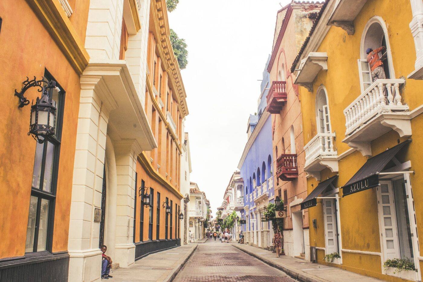 Colourful colonial street with vibrant yellow and orange balconied buildings in Cartagena's old city, Colombia