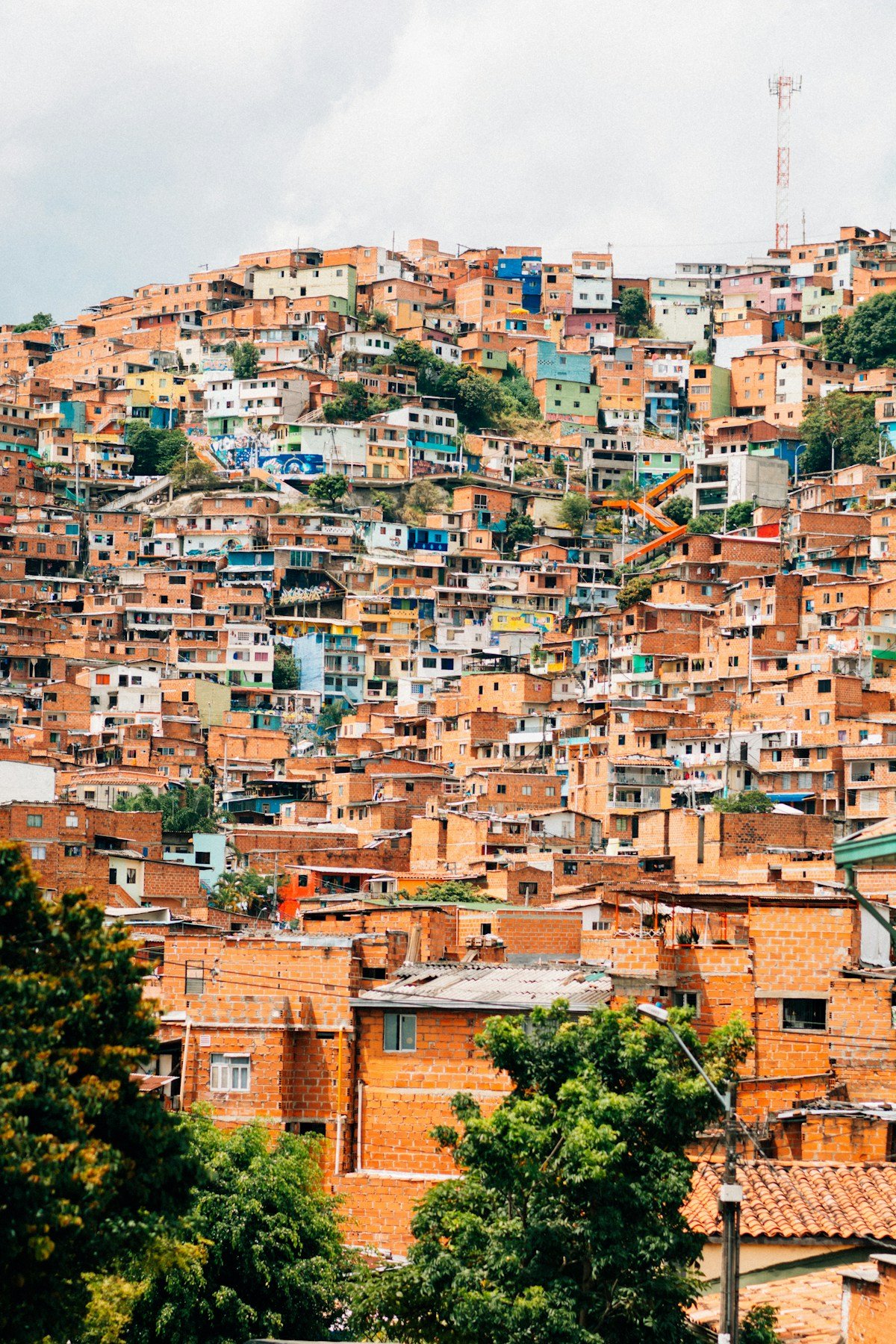 Medellin city panorama with cable cars visible against the green hillside comunas