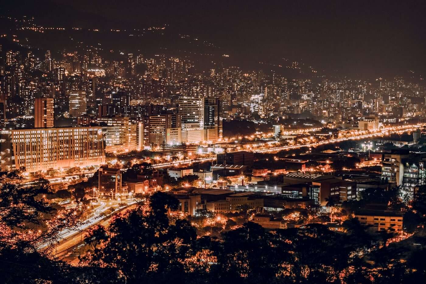 Medellin city skyline glowing with orange lights during the Christmas Alumbrado season, Colombia