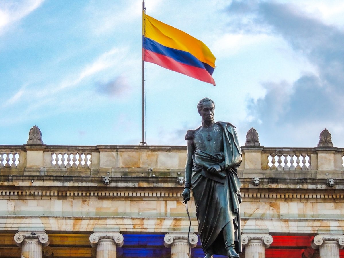 Bolivar statue in front of the Colombian National Capitol building in Bogota with Colombian flag