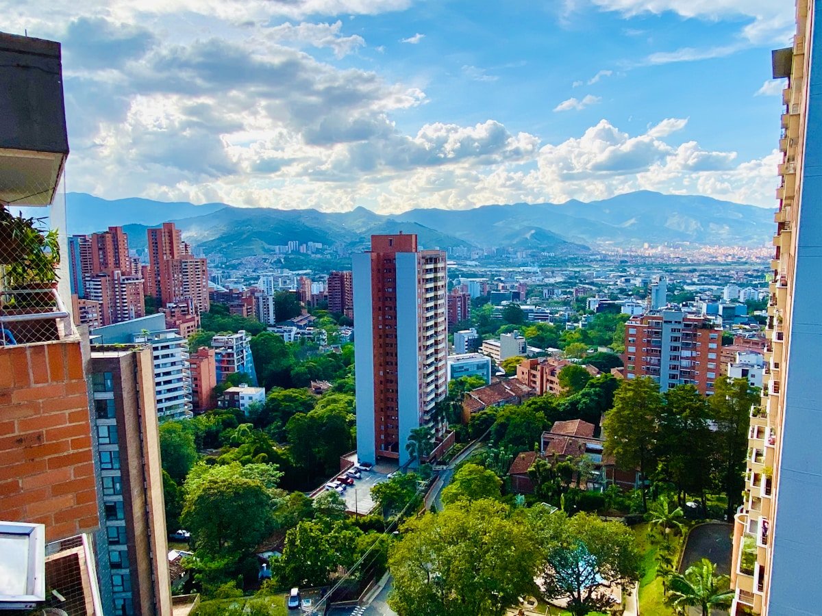 Aerial view of Medellin city with residential towers and the surrounding Andean mountains, Colombia