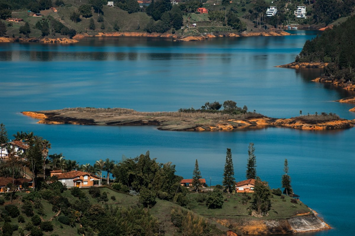 Aerial view of the Guatapé reservoir with houses and islands dotting the blue water, Antioquia, Colombia