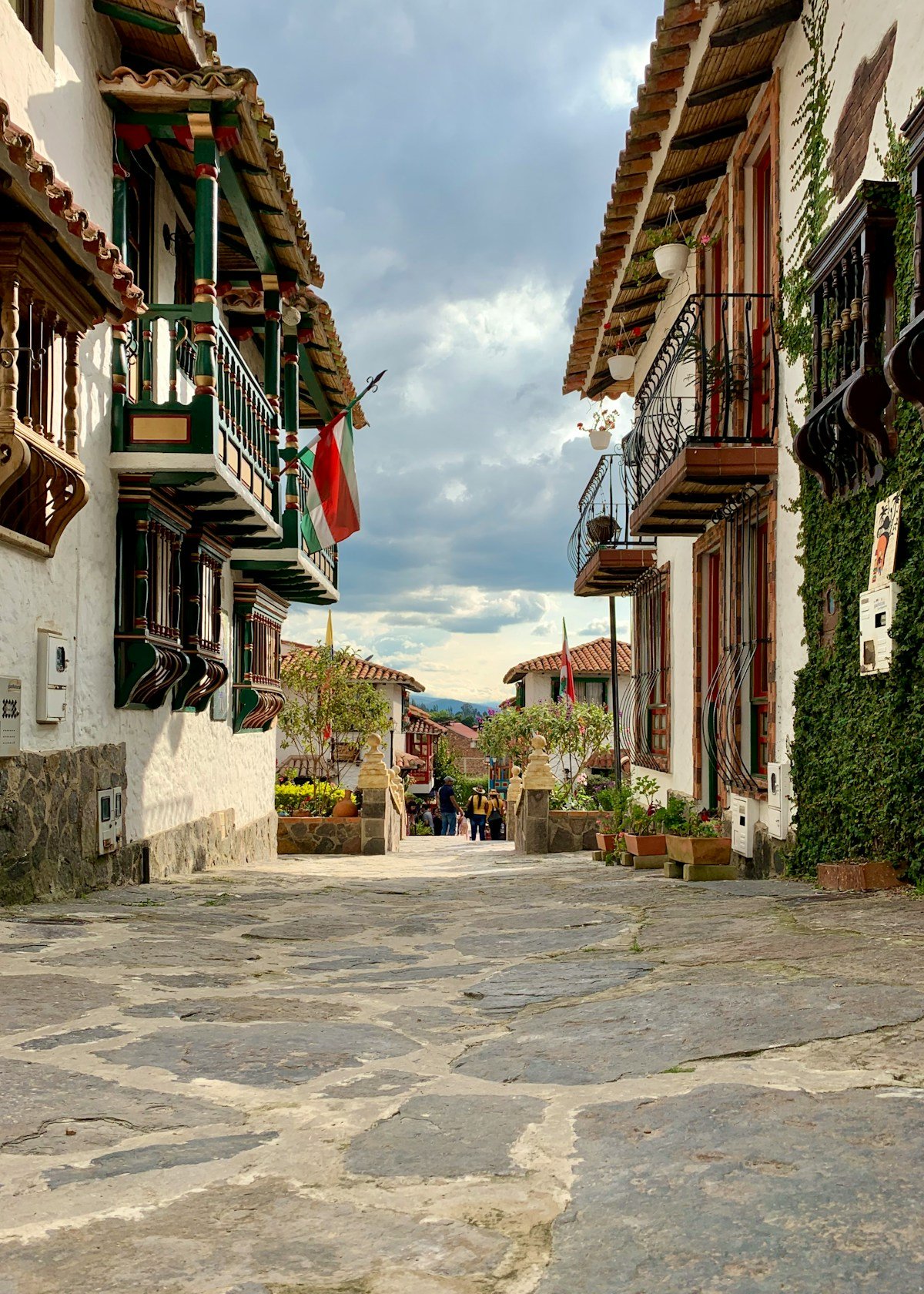 Cobblestone colonial street with whitewashed buildings and iron balconies in a Boyacá village, Colombia