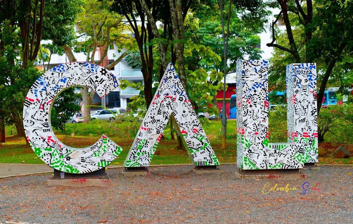Large decorative CALI sign in patriotic Colombian colors in a Cali city park