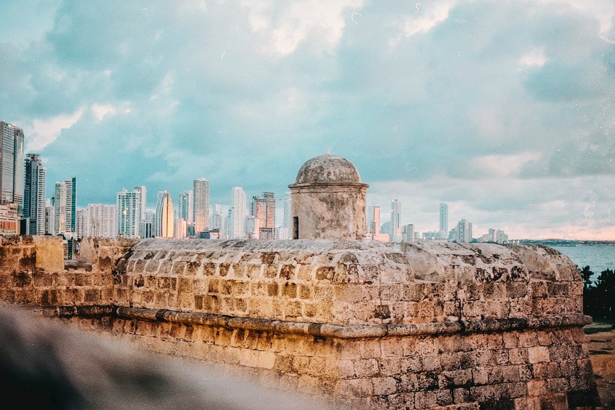 Cartagena's historic city wall with the modern Bocagrande skyline rising behind it