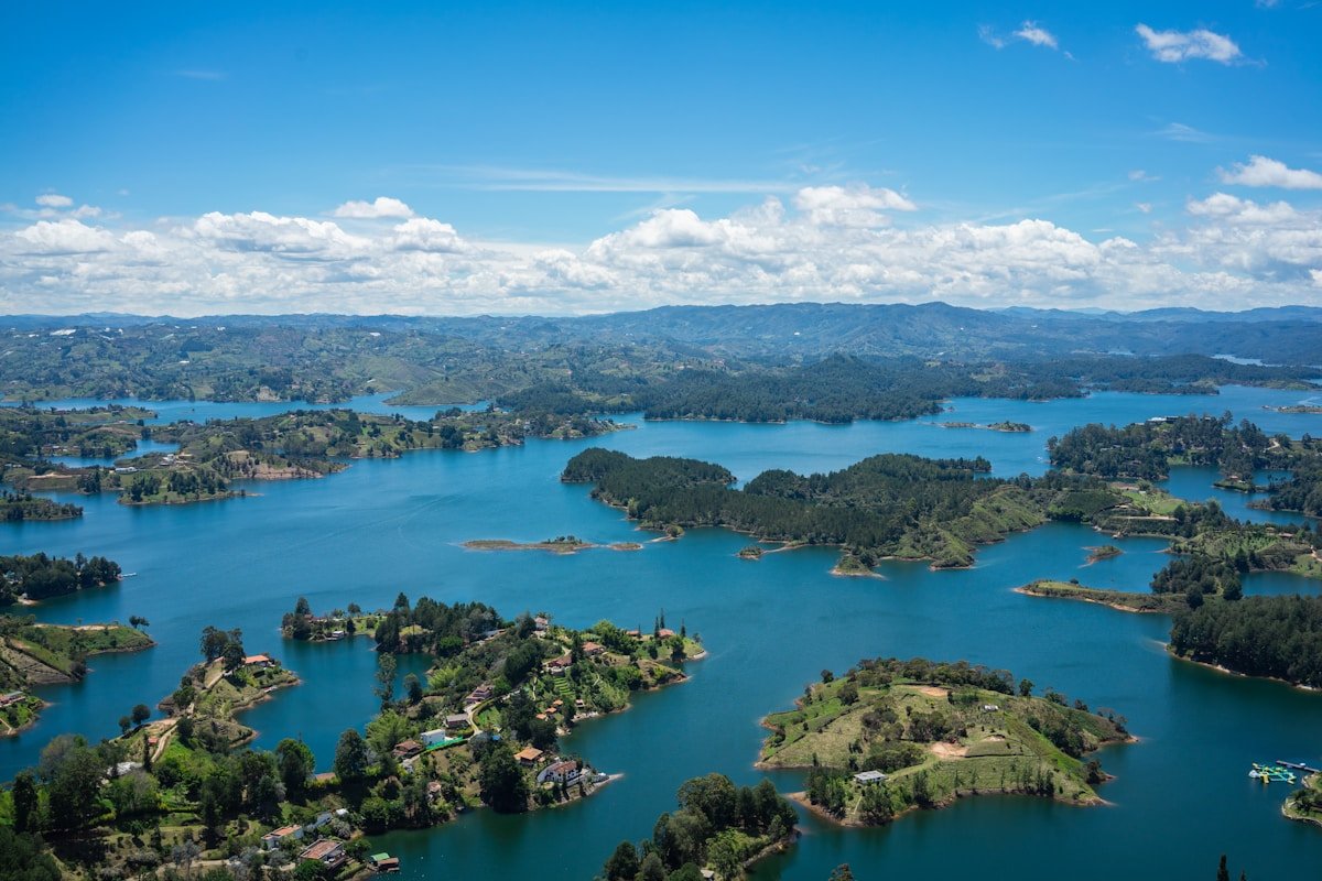 Colourful buildings and islands reflected in the Guatape reservoir, Colombia