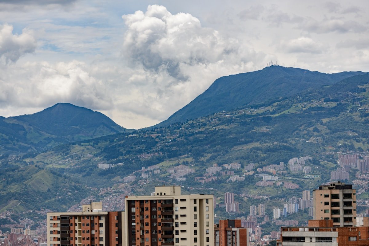 Medellin cityscape with high-rise apartment buildings against green Andean hillsides