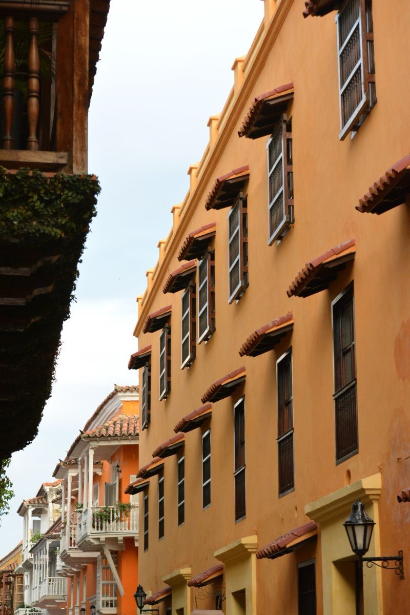 Orange colonial building with balconies on a street in Cartagena old town