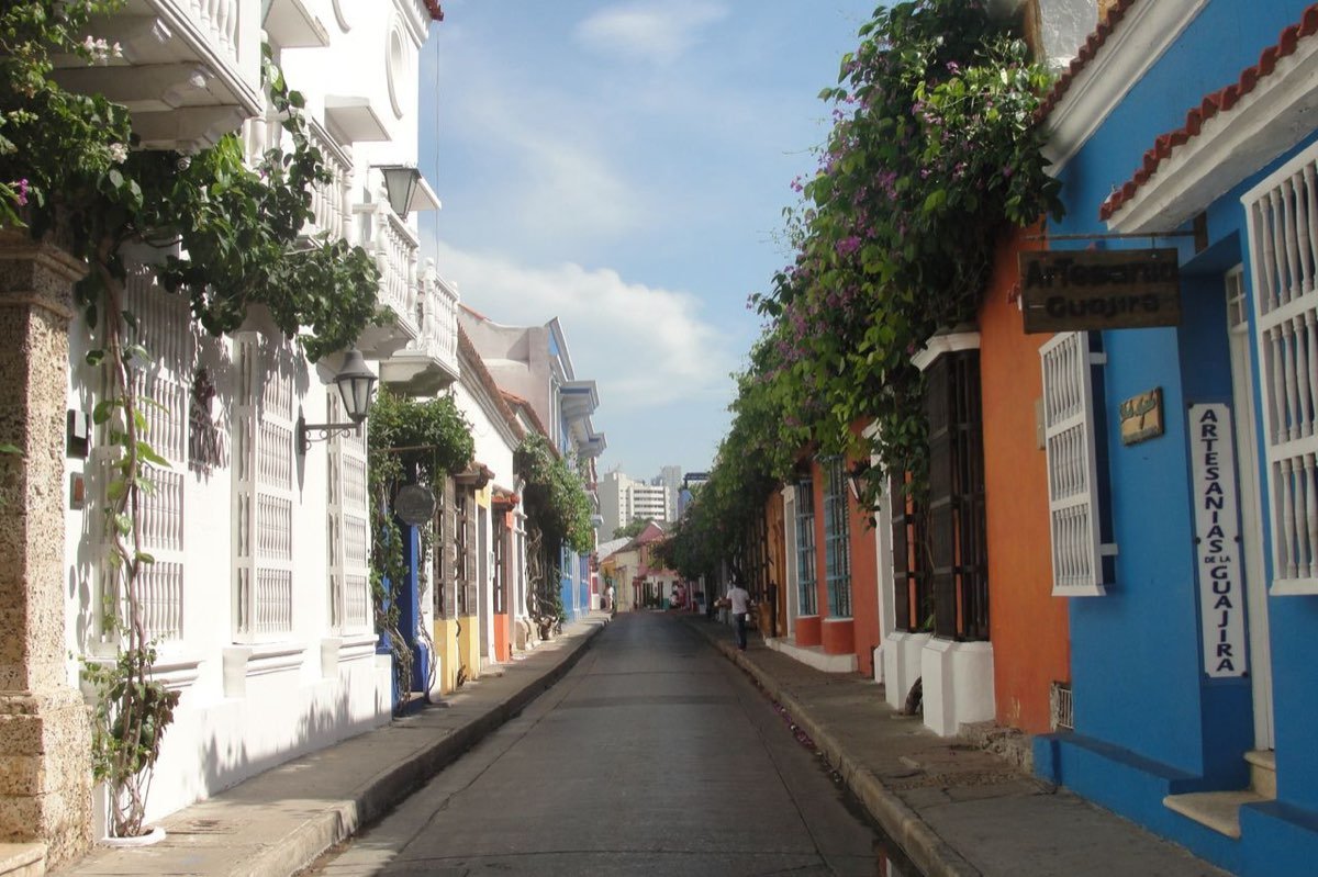 Colourful colonial houses with flowering vines on a lane in Cartagena walled city