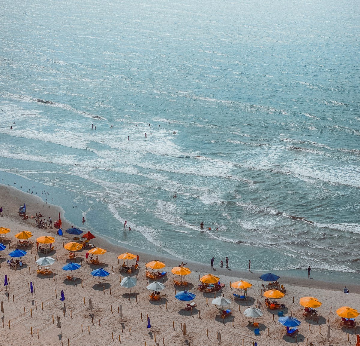 Beach with colourful umbrellas and turquoise water, Caribbean Colombia