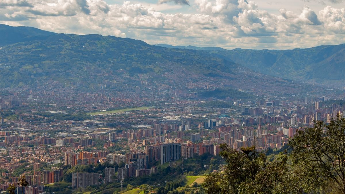 Medellín spread across the Aburrá Valley beneath cloud-covered Andean ridges
