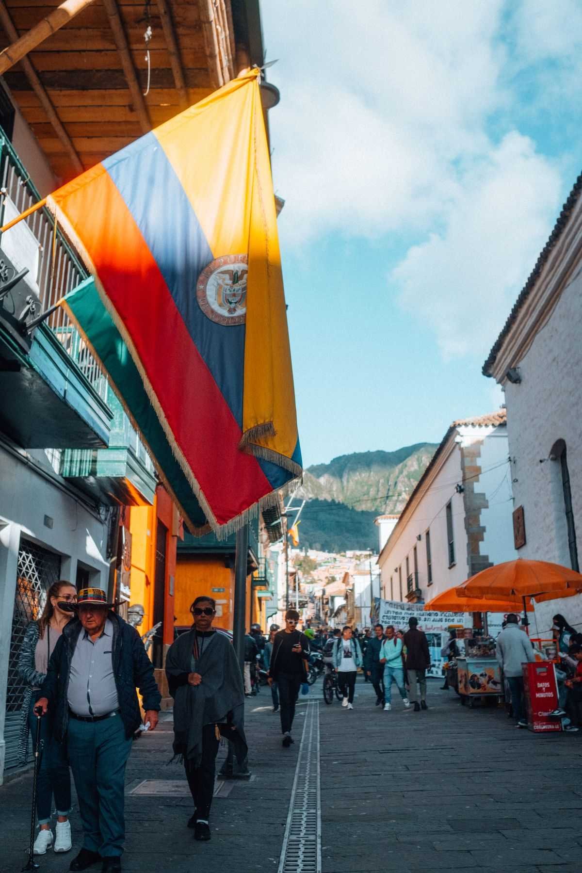Colombian flag hanging over a pedestrian street in La Candelaria, Bogota