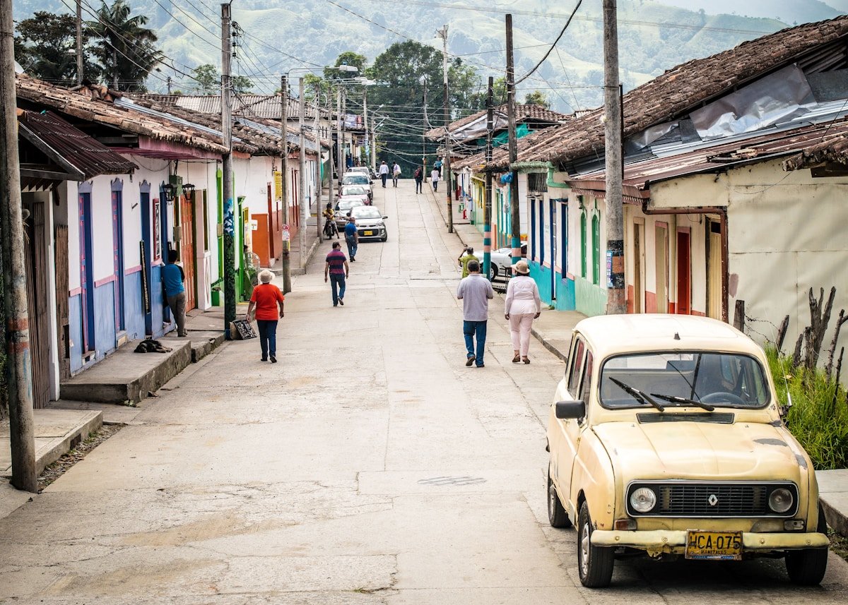 Travellers walking through the colourful streets of Salento, Colombia