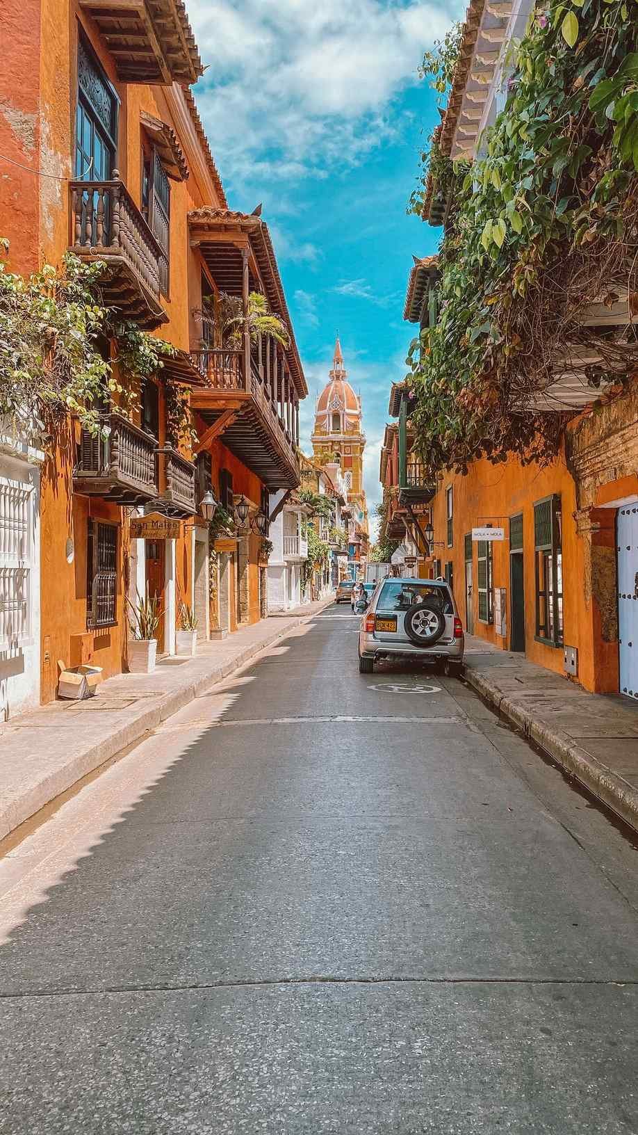 Colourful colonial street leading to the cathedral tower in Cartagena, Colombia