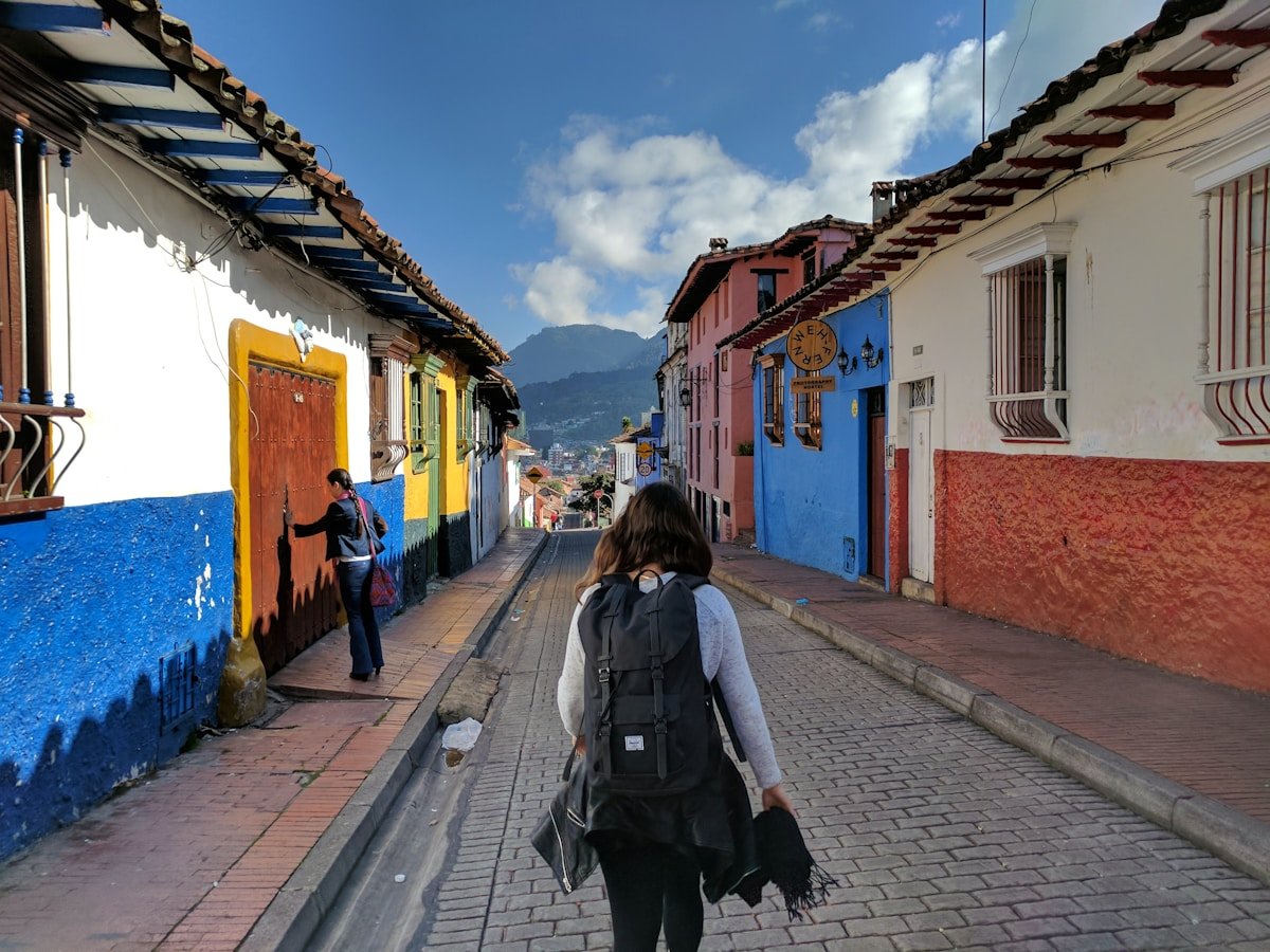 Traveller with backpack walking through La Candelaria historic district in Bogota, Colombia