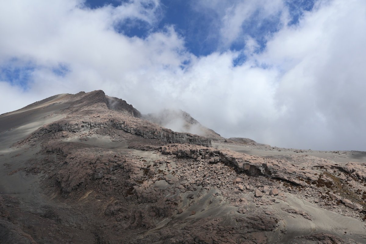 Rocky volcanic summit of a Colombian Andes volcano with volcanic rock and cloud cover