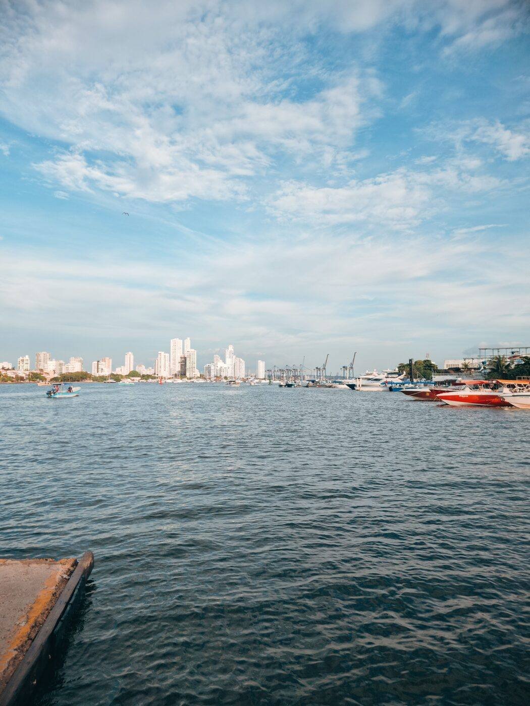 Speed boats moored in Cartagena harbour with the city skyline behind, departure point for Rosario Islands