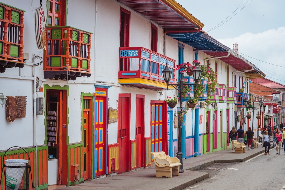 People walking along the colourful main street of Salento, Quindio, Colombia