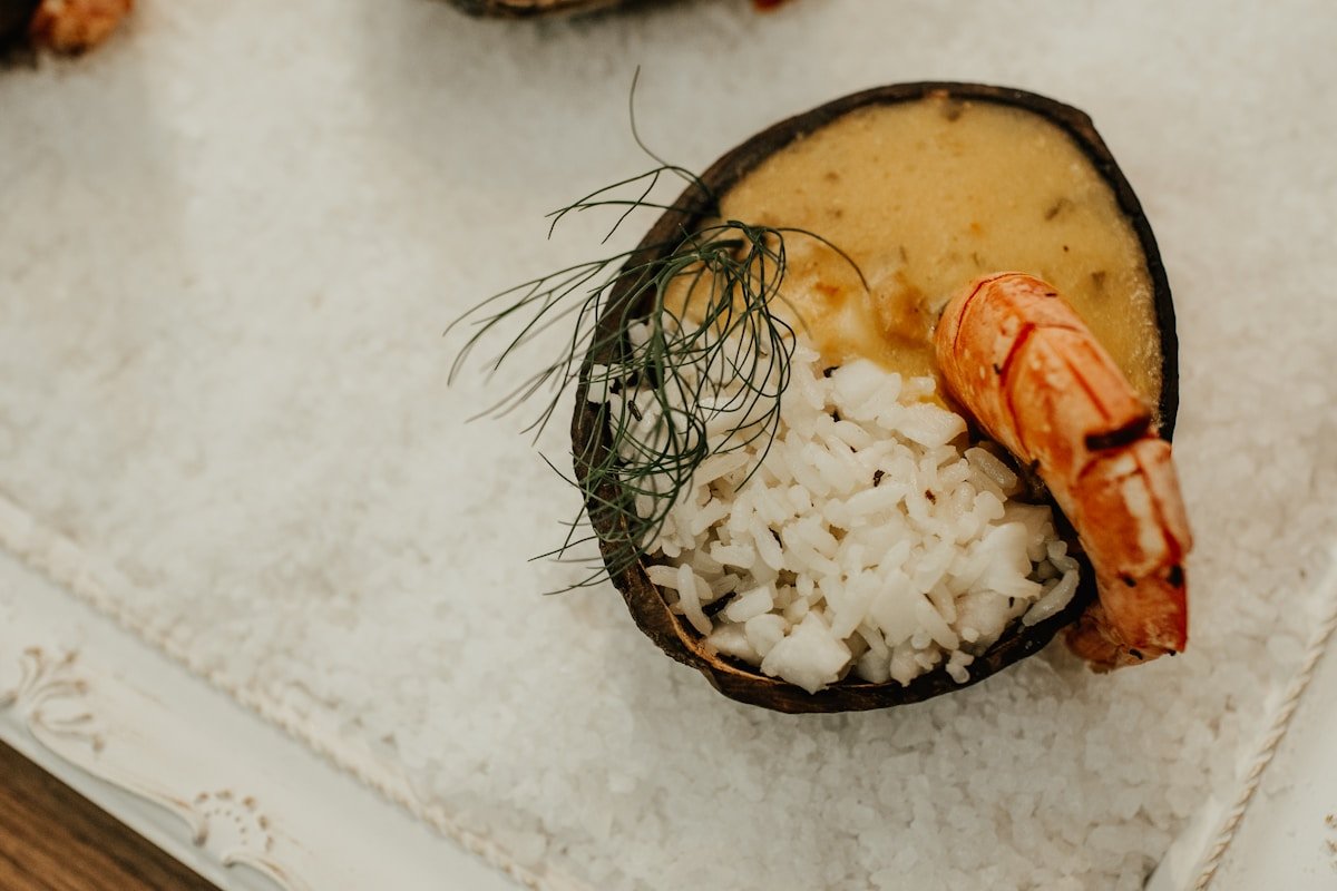 Shrimp with coconut rice served in a coconut shell, traditional Caribbean presentation, San Andres, Colombia